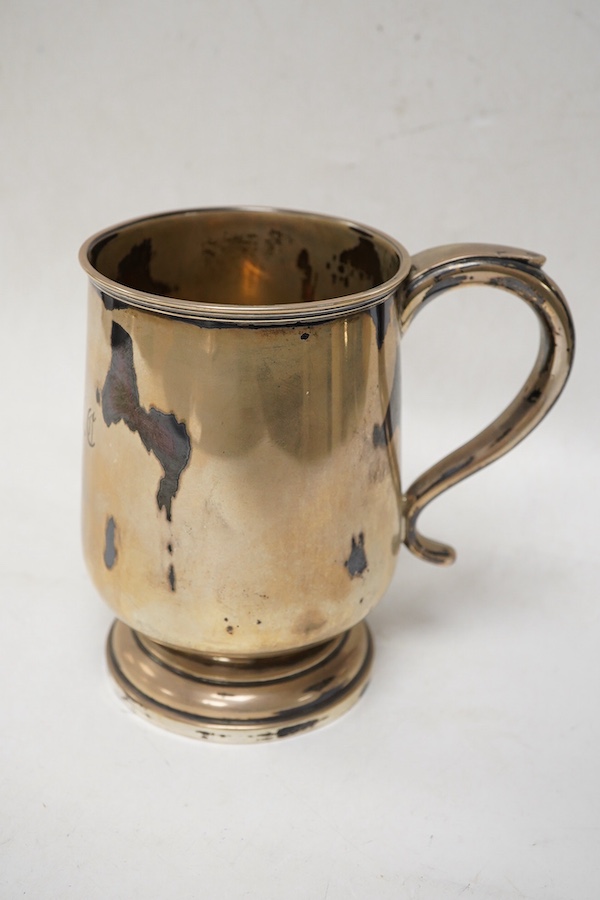 A George V silver mug by Walker & Hall, Sheffield, 1921, on a circular foot, height 12.5cm, 9.5oz.